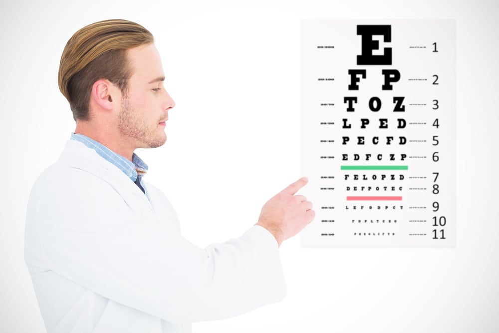 Optician in coat pointing eye test against eye test
