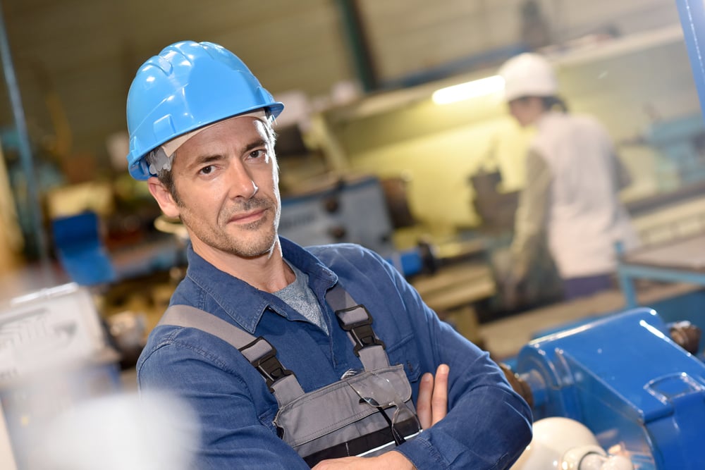 Portrait of mature metal worker standing in workshop