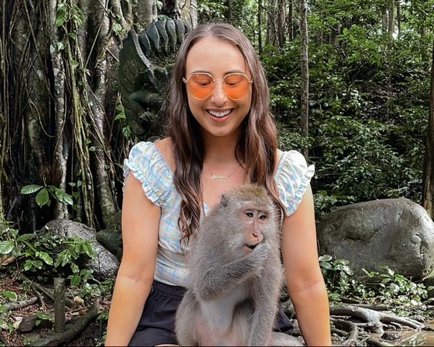 A person holding a monkey

Description automatically generated with medium confidence