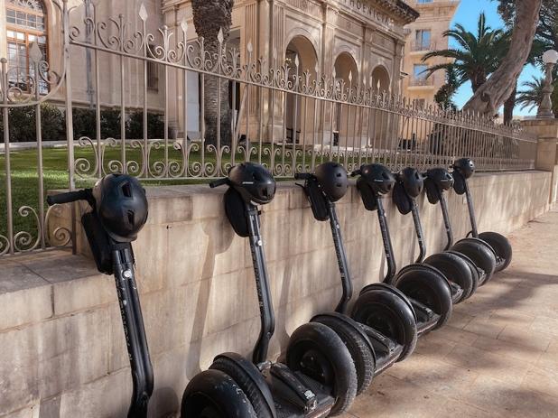 A row of segways parked on a wall

Description automatically generated with low confidence